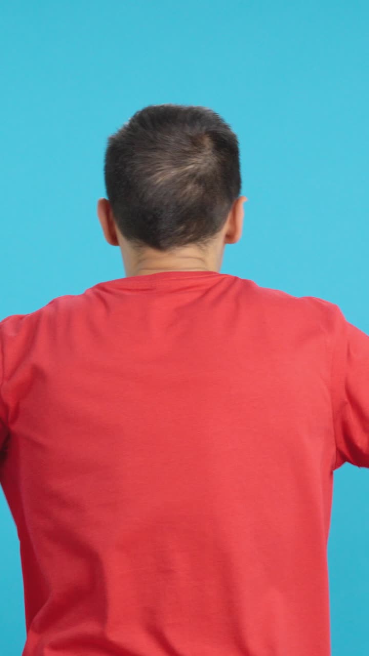 Rear view of a man waving a vietnamese pennant