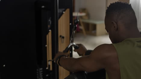 man performing lat pulldown exercise in gym