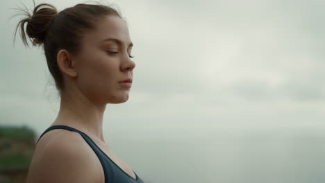 Profile-girl-turning-face-to-camera-confidently-close-up.-Woman-practicing-yoga.