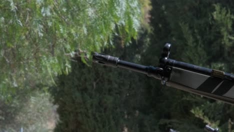 close-up side view of the barrel of several rifles shooting at the same time