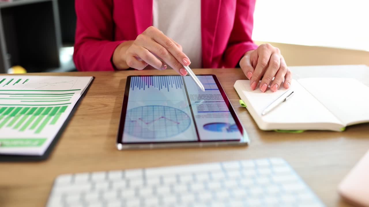 Professional analyzing business data and reports on a digital tablet