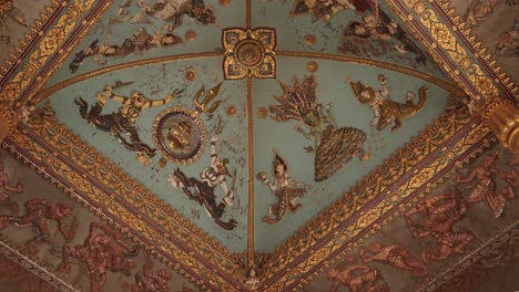 looking up at the detailed and colorful paintings on the interior of patuxai victory monument in the center of vientiane, laos