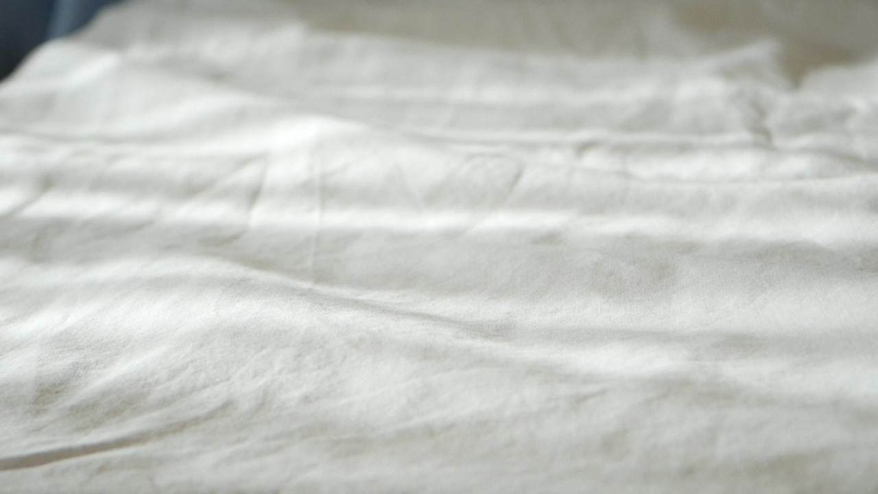 Sunlight and Shadows Moving Across White Bed Sheets