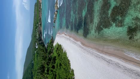 Aerial-flyover-sandy-beach-of-Quemaito-and-coral-reef-at-shoreline-in-summer-season---Barahona,-Dominican-Republic