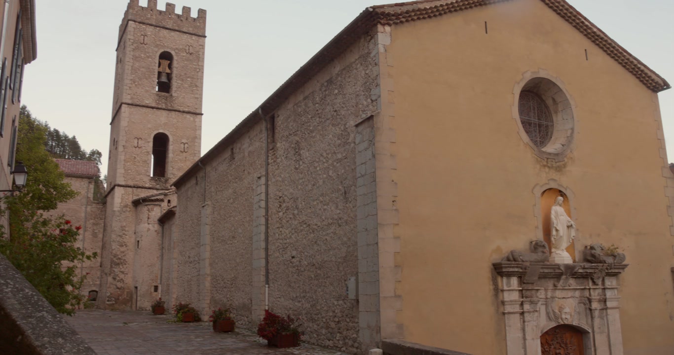 Ancient stone church with bell tower in Entrevaux, one of France's most beautiful villages. Medieval religious architecture in Provence-Alpes-Côte d'Azur region showcasing French heritage.