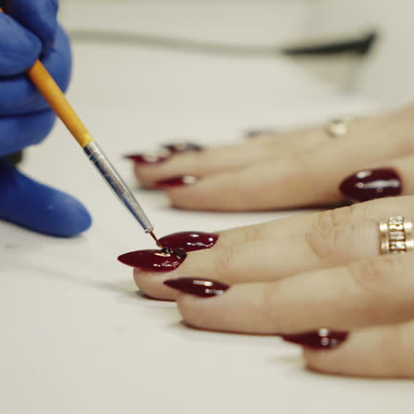 manicure concept. professional manicurist glues rhinestones on nails square video