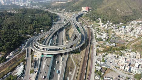 traffic on a massive highway interchange with multiple levels and loop shaped road in hong kong, aerial view