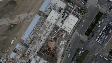 rotating crane over active construction site in paris, urban infrastructure, france. aerial top-down orbiting