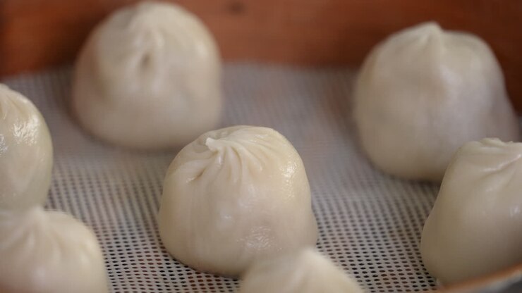 Steaming pork soup dumplings named Xiao long bao in Taiwan.