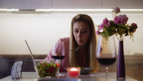 lady eats vegetarian salad at served table at festive dinner