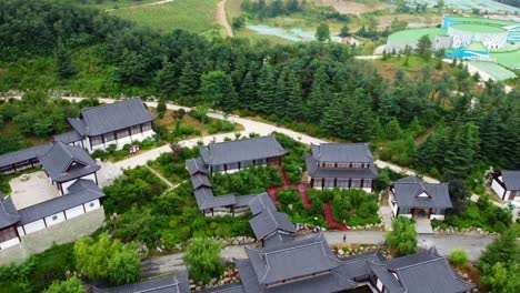 aerial panoramic view over huaxiacheng park in weihai city drone fly above traditional chinese temple architecture building