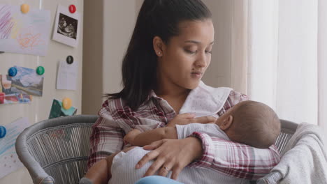 young mother breastfeeding baby at home nursing infant enjoying motherhood