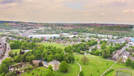 Aerial-shot-above-a-countryside-town-with-fields,-trees-and-woodland-in-England