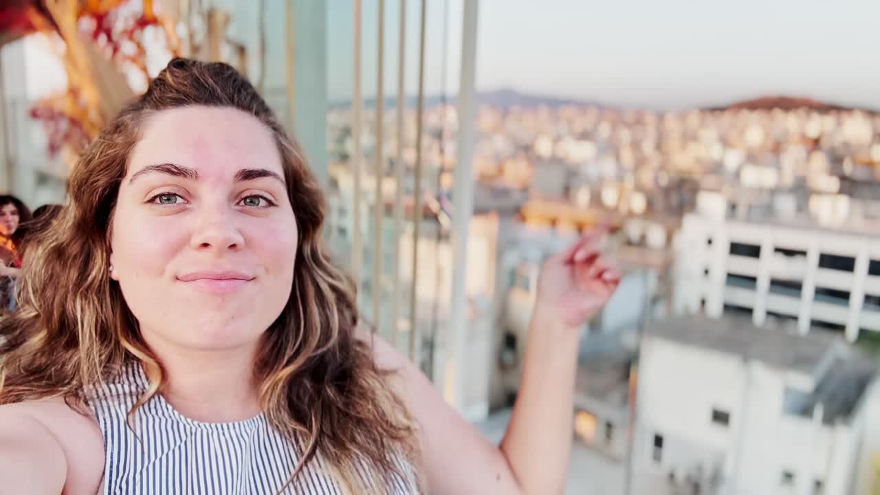 Joyful Woman Vlogging on Athens Hotel Rooftop