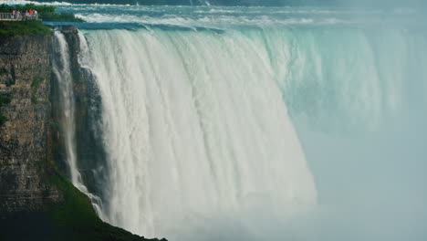 the setting sun illuminates niagara falls and the river surrounded by forest beautiful landscape wit