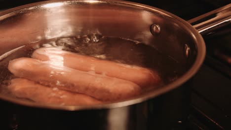 plantbased hotdogs boiling and cooking in water