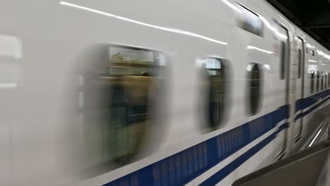 a train speeds through a modern station platform