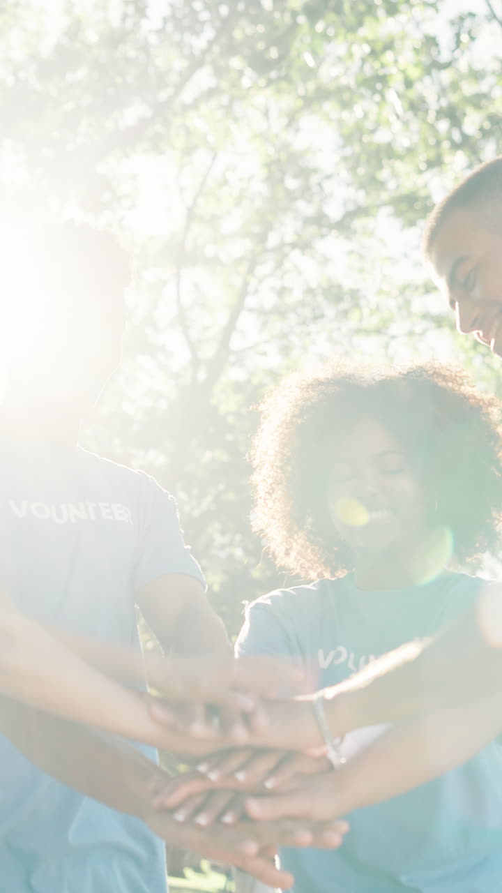 Happy Young Volunteers Celebrating Teamwork Outdoors