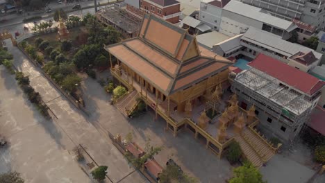 majestic imposing hall of the golden temple of phnom penh in cambodia - aerial orbit shot