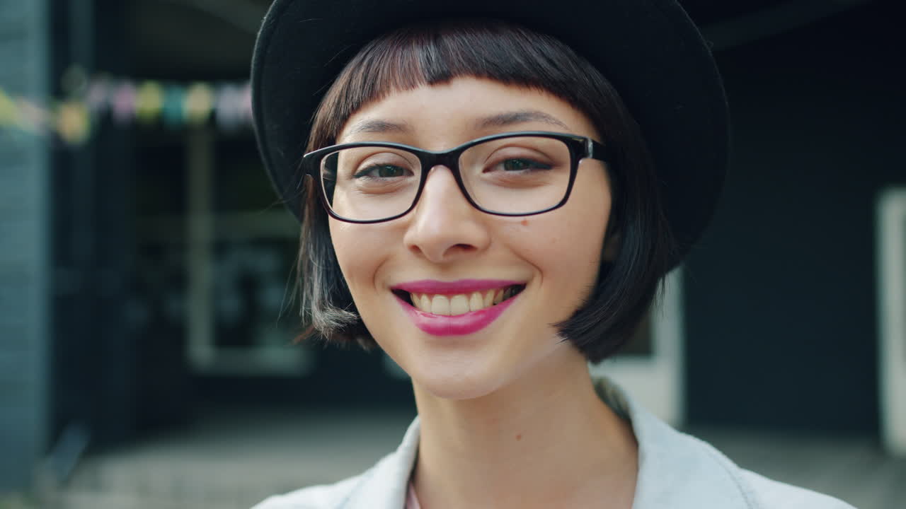 Smiling woman with glasses and hat