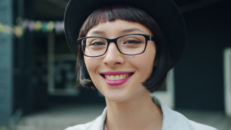 smiling woman with glasses and hat