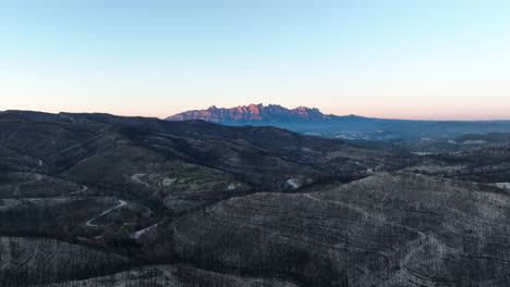 vista aérea de vastos árboles de incendios forestales desastre natural debajo del brillante amanecer de la cordillera de monserrat