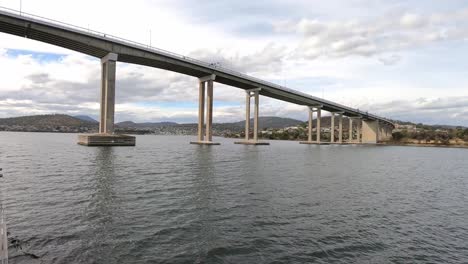 good view of the tasman bridge in hobart as a tourist boat passes beneath