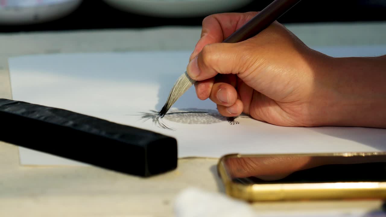 Slow Motion Footage of a Japanese Man Painting a Nihonga, a Traditional Japanese Painting, with Brushes and Black Ink