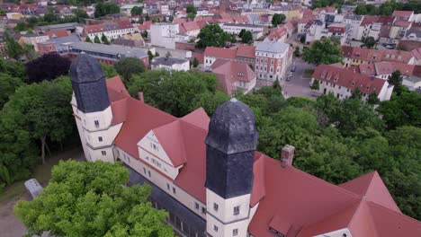 aerial-of-the-2-towers-of-Köthen-castle-in-Germany,-rotating-drone-shot