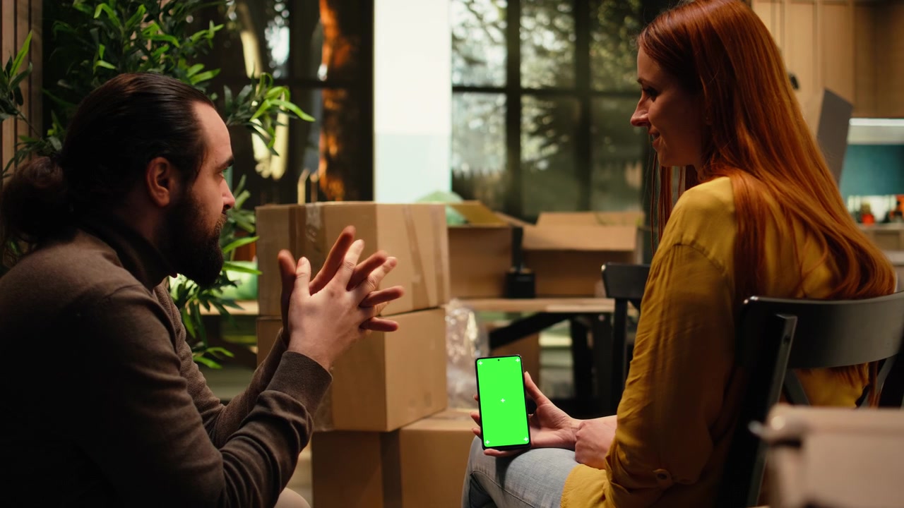 Couple Discussing Content on Smartphone with Green Screen