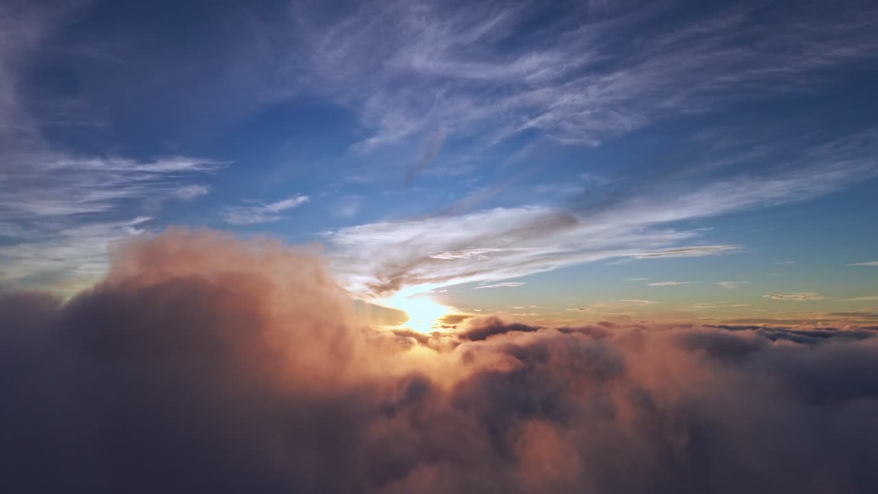 Breathtaking drone footage of sunrise above the clouds with golden light and dramatic skies, perfect for cinematic, travel, and inspirational projects