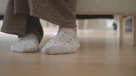feet with socks on a wooden floor