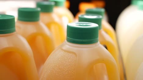 plastic bottle of orange juice in a shelf ,