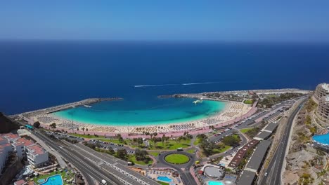 summer flight over of the sunny amadores beach (playa de amadores) and turquoise sea, puerto rico de gran canaria, canary islands, spain