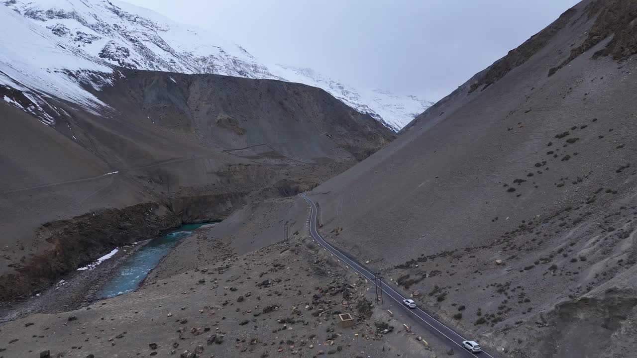Mountain Valley Road with Snow-Capped Peaks
