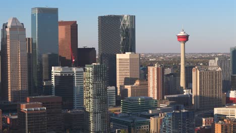 a aerial drone turns in on the downtown core focusing on the calgary tower on a beautiful sunny summer day