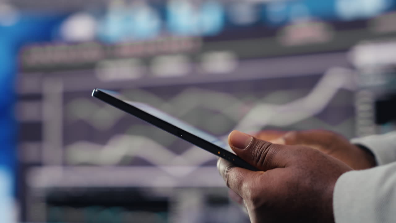 Black male business leader in a digital environment focused on charts