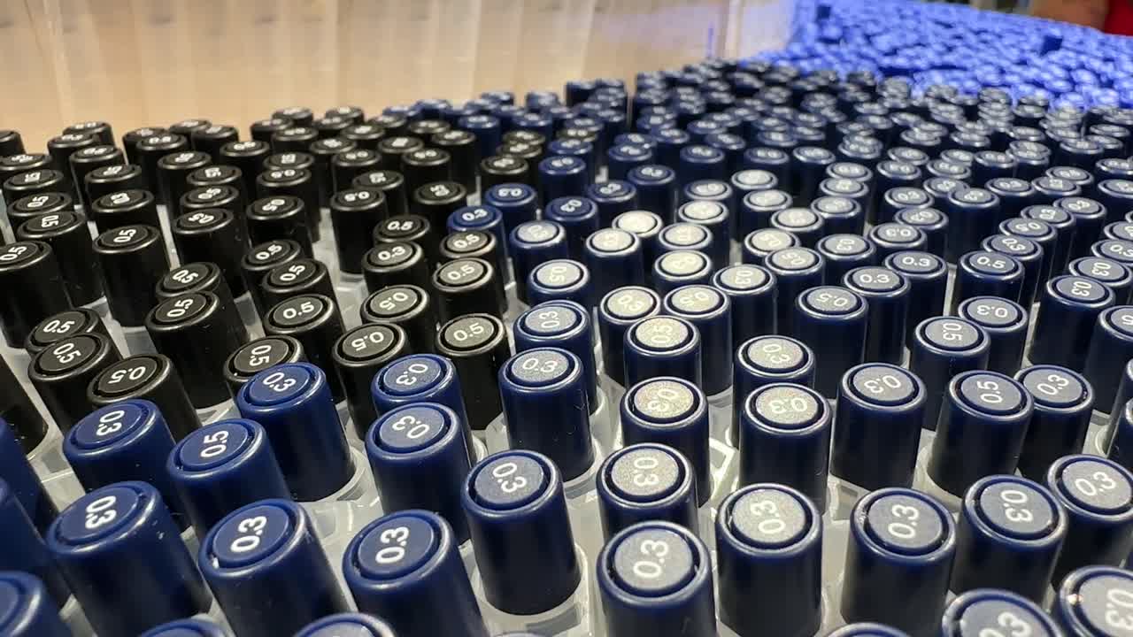 Hundreds multiple Dark Blue Pens stationery store. Tops visible grouped vertically in array