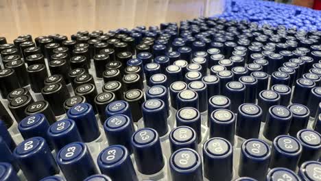 hundreds multiple dark blue pens stationery store. tops visible grouped vertically in array