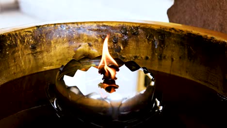 a flickering flame in a temple setting