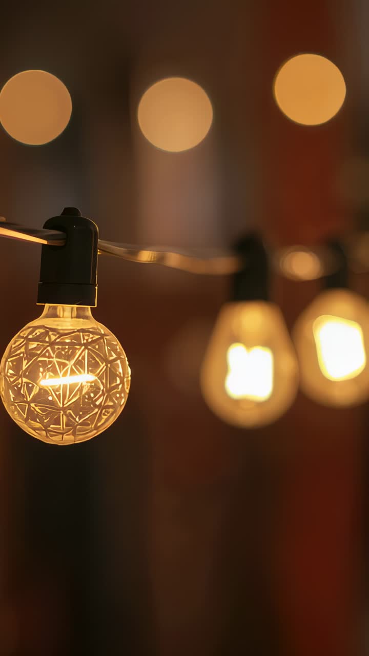 Vertical video: Shifting glow causing textured bulb flickering left with clip and bokeh, copy space