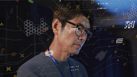 analyzing digital data with futuristic animation, man wearing glasses in office