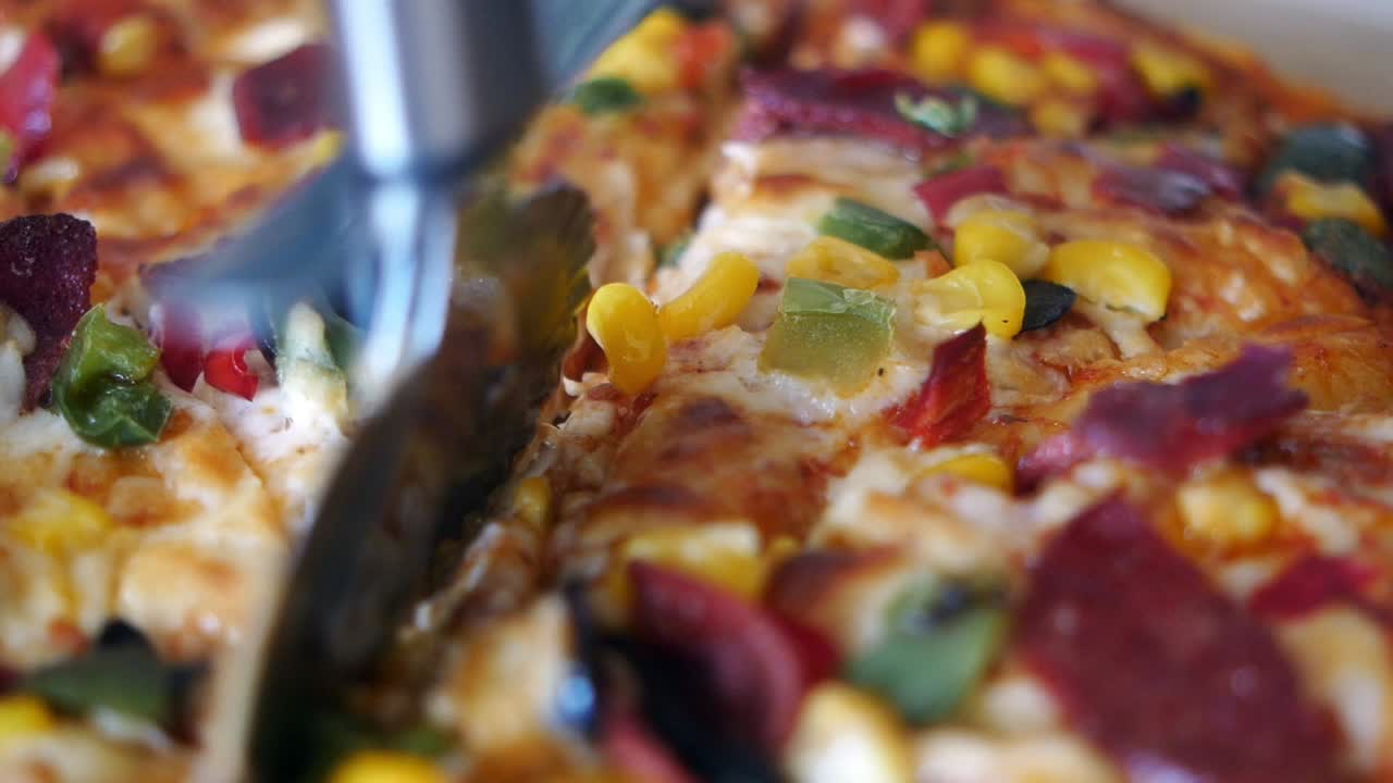 Pizza with Corn, Peppers, Olives, and Meat Toppings