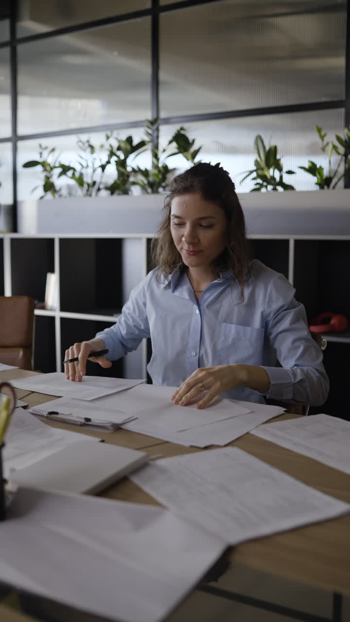 Business Woman Reviewing Documents in Office