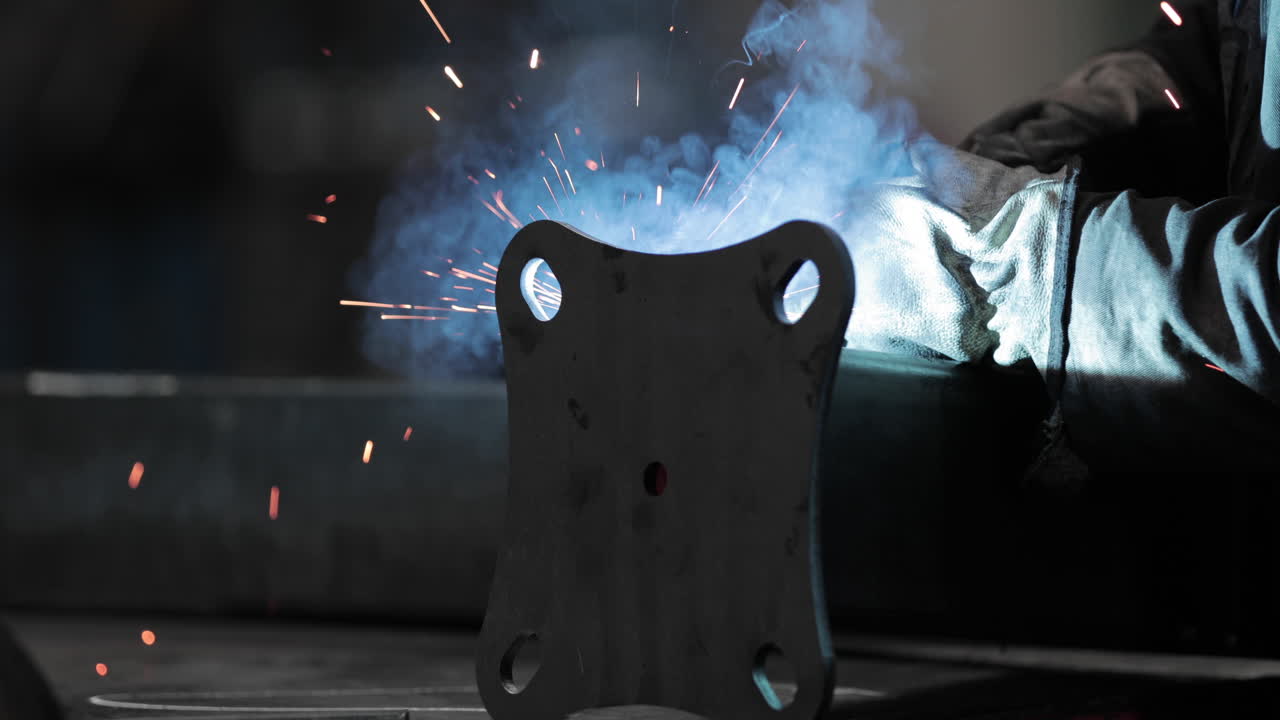 Steelworker Welding Base Plate To Metal Tubular Pipe - slow motion, slider shot