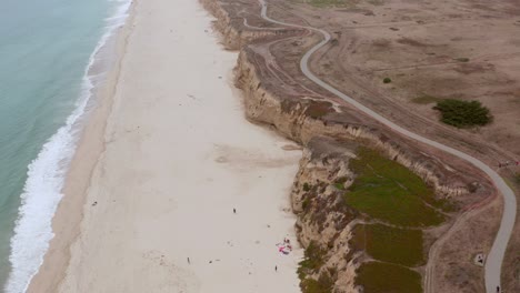 AERIAL:-drone,-half-moon-bay-beach-cliffs-and-shore,-flying-forward-view