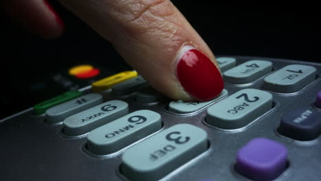 Woman inserting credit card in pos terminal.Female entering pin code on terminal