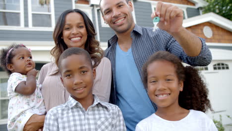 Portrait-Of-Family-With-Keys-To-New-Home-In-Slow-Motion