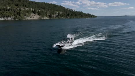 aerial: wakeboarding behind speedboat on flathead lake, kalispell, montana