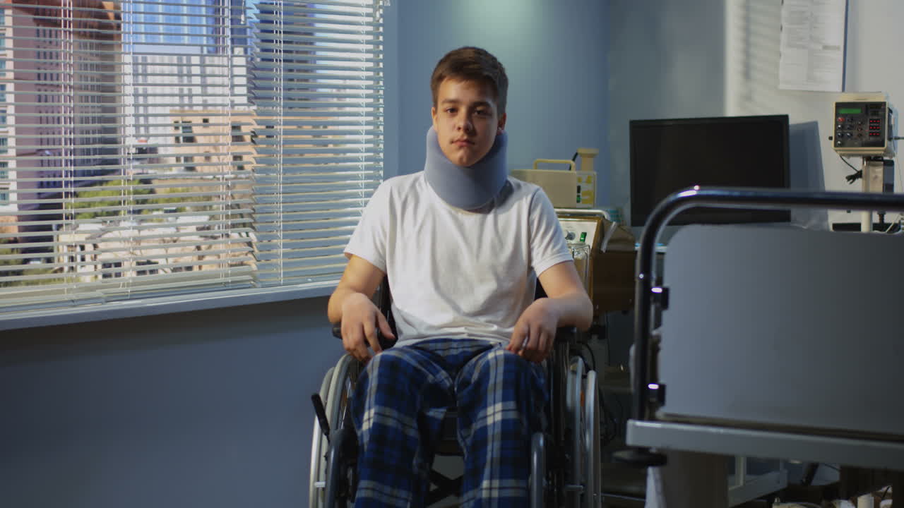 Injured Teenager in Hospital Wheelchair